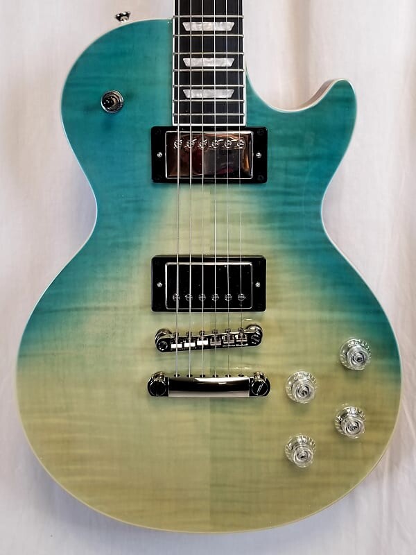 Электрогитара Epiphone Les Paul Modern Figured, топ из огненного клена, накладка на гриф из черного дерева, Карибский синий Fade 2023 EILMFCBFNH1
Электрогитара Epiphone Les Paul Modern Figured, топ из огненного клена, накладка на гриф из черного дерева, Карибский синий Fade 2023 EILMFCBFNH1