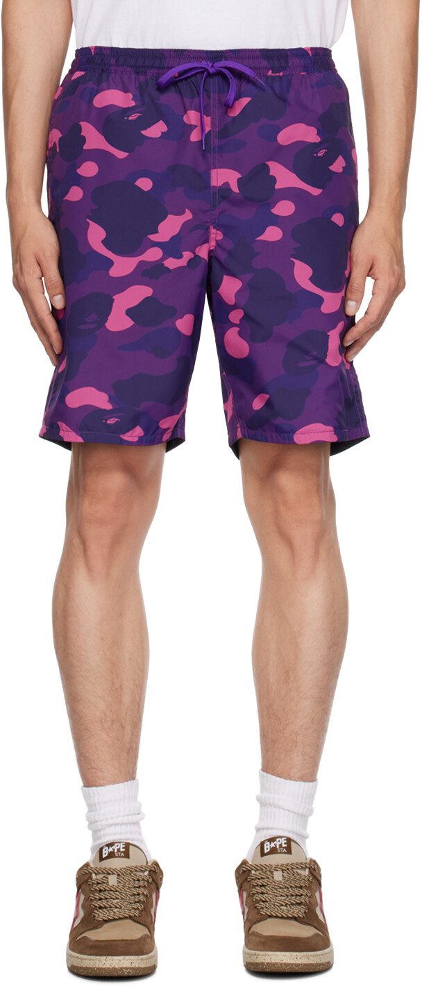 BAPE Двусторонние шорты фиолетового цвета с камуфляжным принтом и изображением акулы
BAPE Двусторонние шорты фиолетового цвета с камуфляжным принтом и изображением акулы