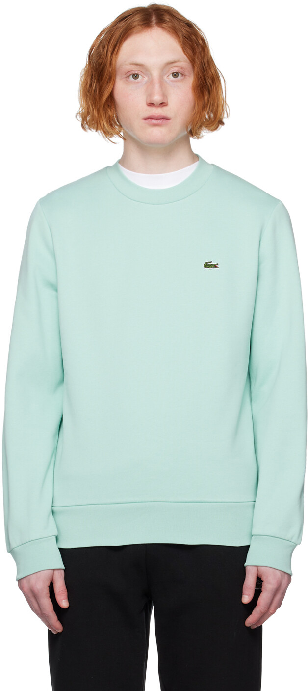 

Синяя толстовка с нашивками Lacoste