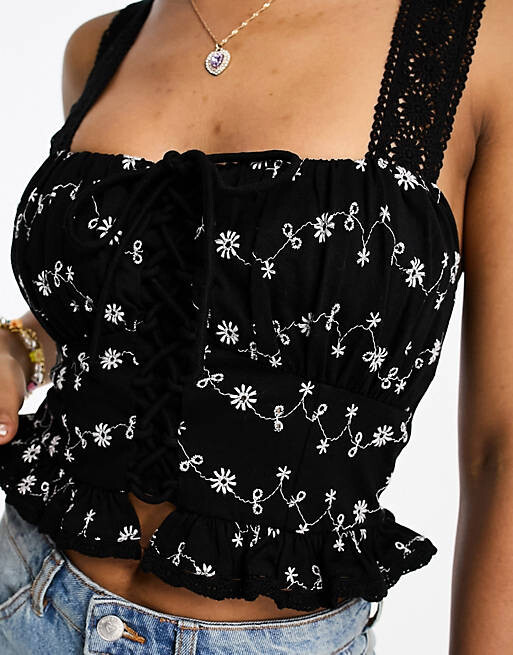 

Черно-белый топ с вышивкой и шнуровкой спереди ASOS DESIGN