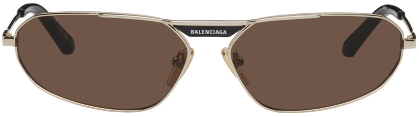 

Золотые овальные солнцезащитные очки Balenciaga
