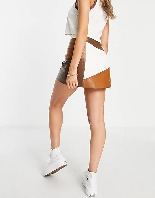 

Коричнево-кремовая мини-юбка из искусственной кожи в стиле пэчворк ASOS DESIGN