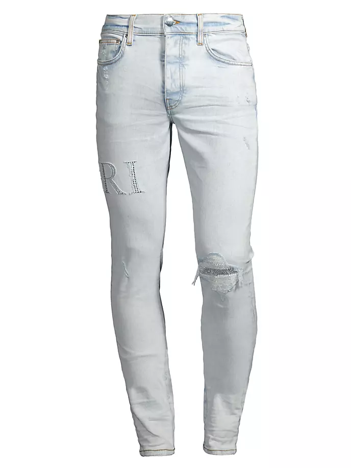 

Рваные джинсы с кристаллическим логотипом Amiri, цвет bleached indigo