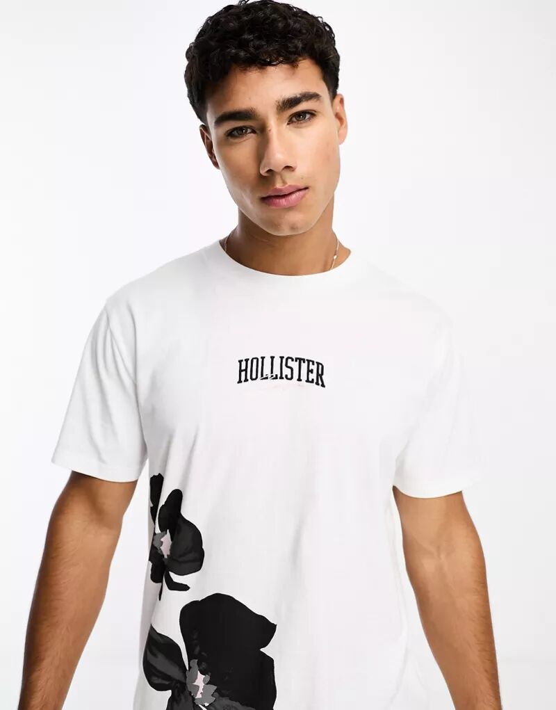 Белая футболка Hollister с цветочным принтом-логотипом в центре