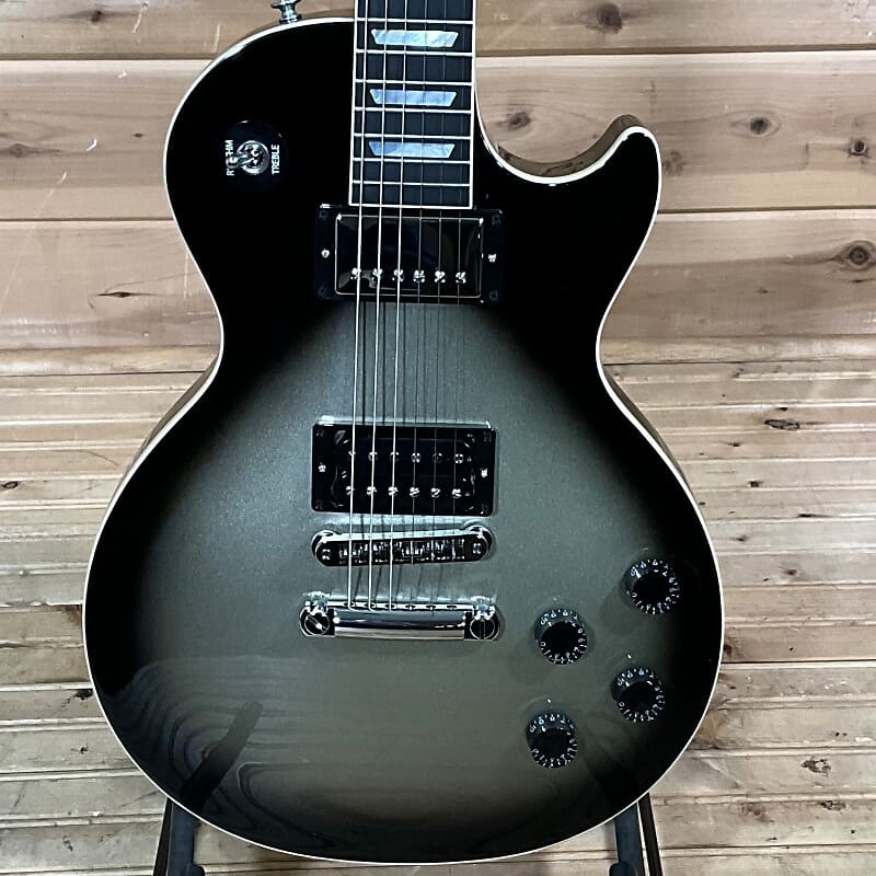 

Gibson Adam Jones Les Paul Standard Электрогитара - Silverburst Adam Jones Les Paul Standard Electric Guitar - Silverburst