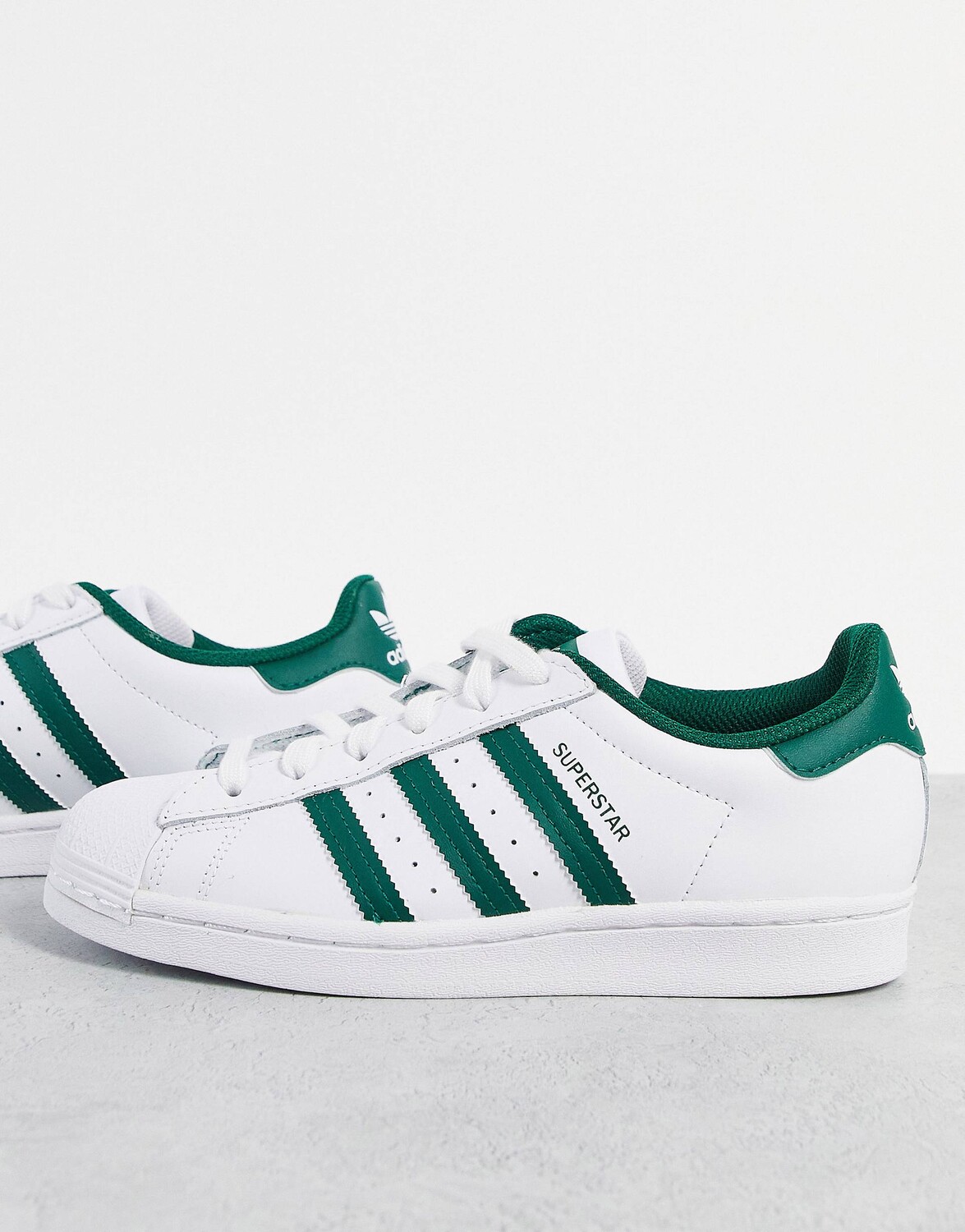 

Белые кроссовки adidas Originals Superstar с студенческими зелеными полосками