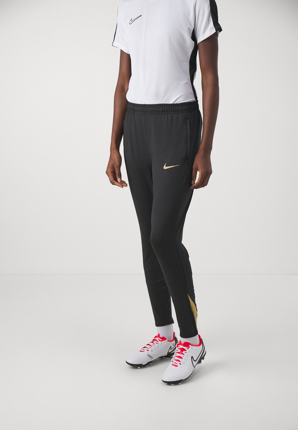Брюки для бега STRIKE PANT Nike, цвет black/jersey gold/metallic gold цена и фото