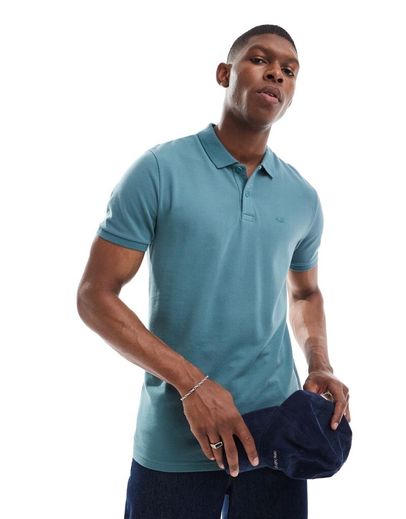 

Hollister - Icon - рубашка-поло из пике синего цвета с логотипом и декоративной отделкой