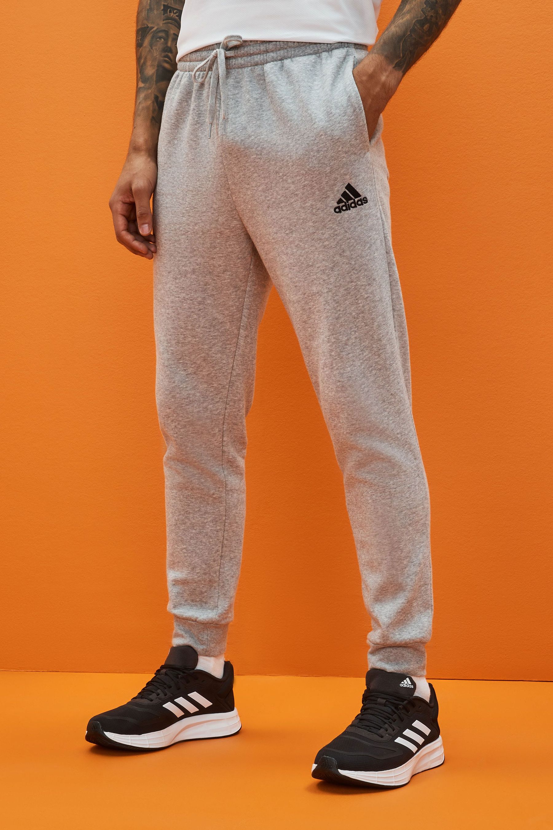 

Sportswear Essentials стандартного кроя с зауженными штанинами adidas, серый