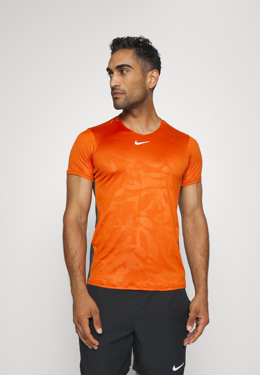 

Спортивная футболка M NKCT DF ADVTG TOP PRINT Nike, оранжевый у костра/глубокие джунгли/белый