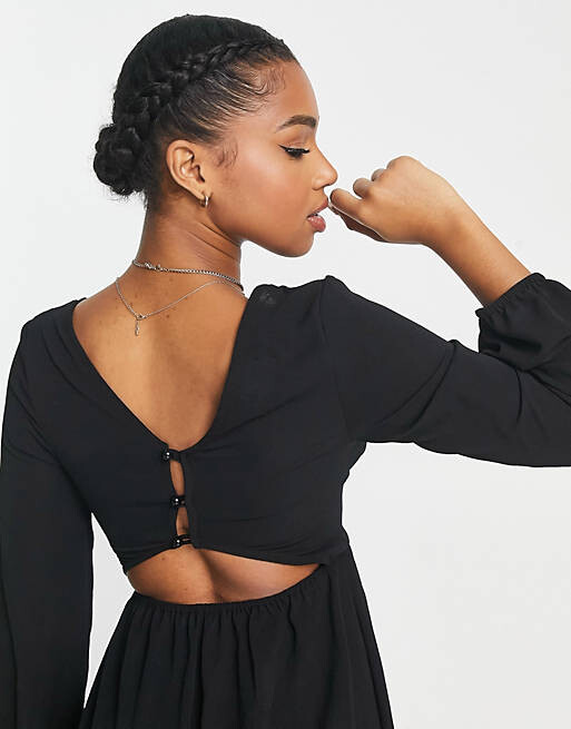 

Черный комбинезон из крепа с пуговицами и длинными рукавами на спине ASOS DESIGN