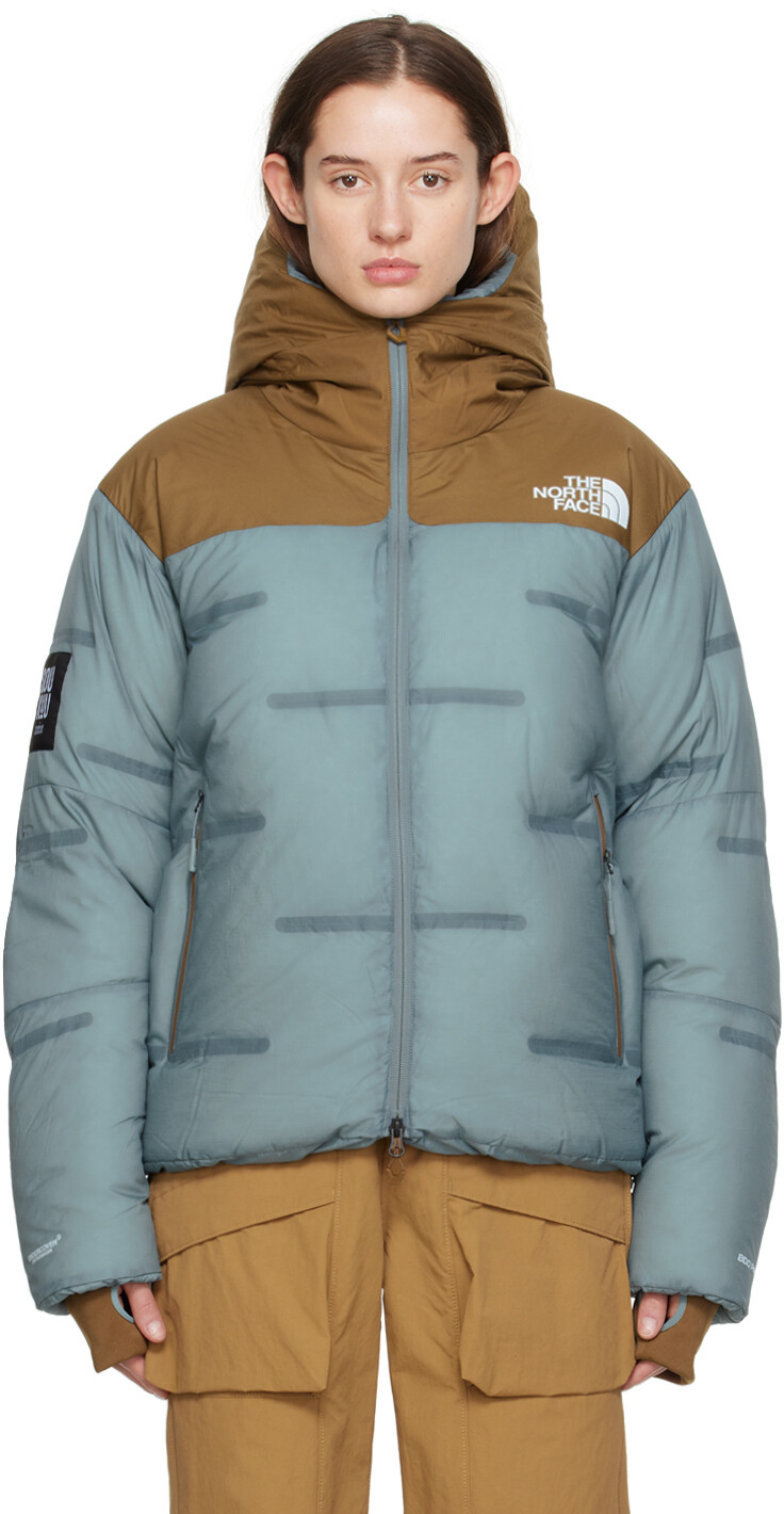 

Синий и коричневый пуховик The North Face Edition Nuptse Undercover