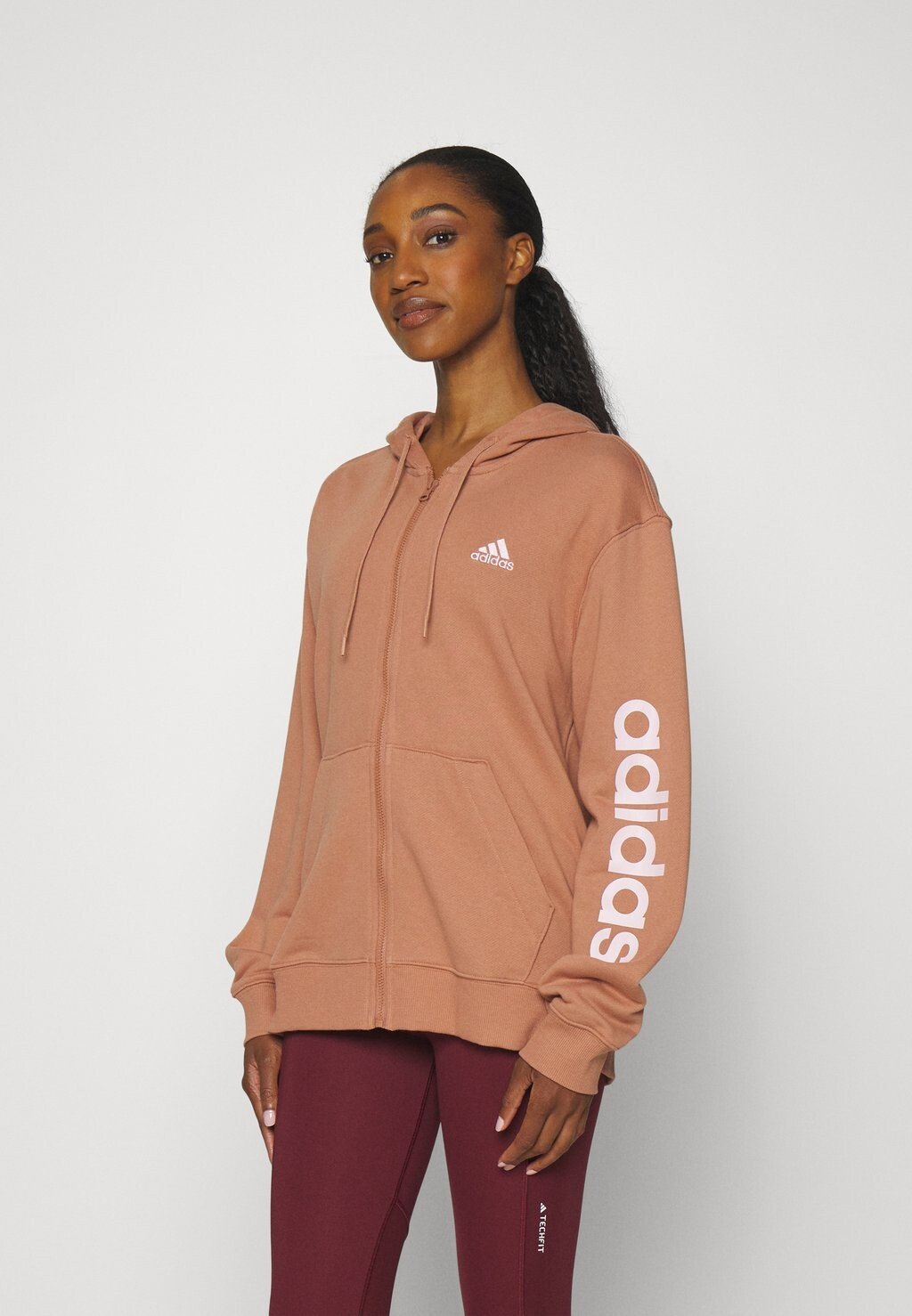 

Толстовка на молнии adidas Sportswear, Clay Strata/прозрачно-розовый
