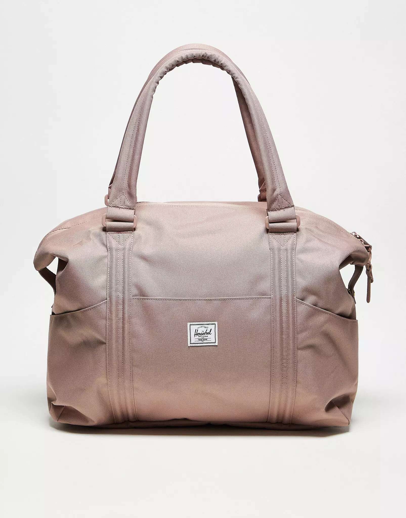 Светло-розовая дорожная сумка Herschel Supply Co. Strand