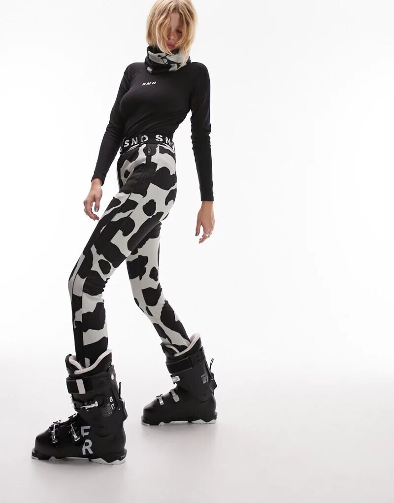 

Эластичные лыжные брюки Topshop Sno с разноцветным коровьим принтом, узкими штанинами и ремешком