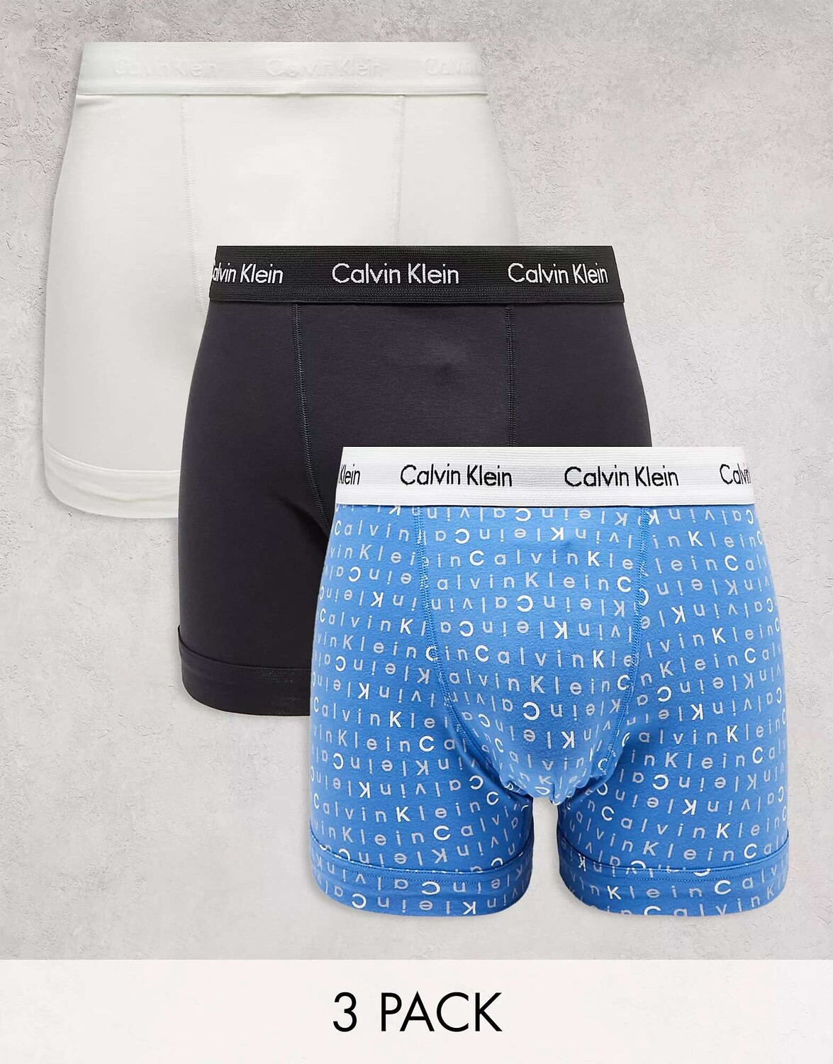

Три пары плавок Calvin Klein в синем, черном и сером цветах с принтом
