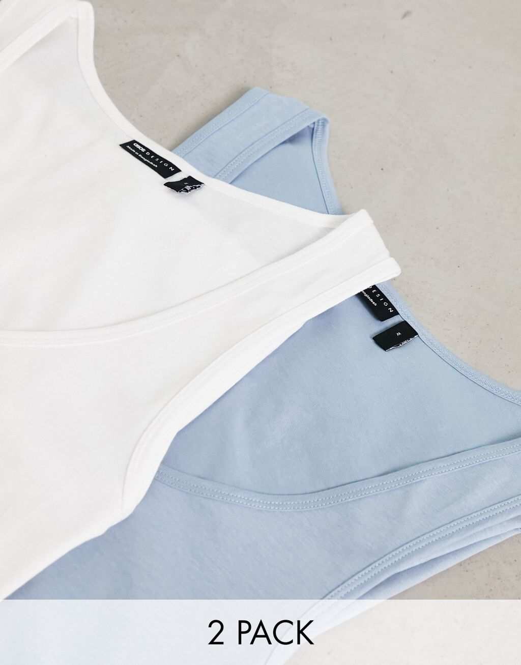 

Бело-синий комплект из двух жилетов с овальным вырезом ASOS DESIGN